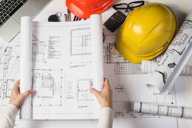 person-opening-blueprint-23-2147710988.jpg